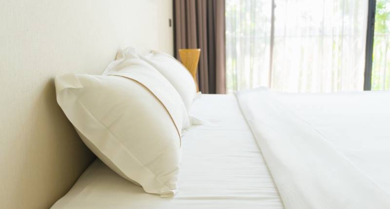 A snuggly fit crisp white bed sheet 