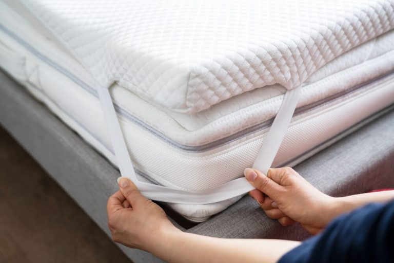 Placing a mattress topper around a mattress