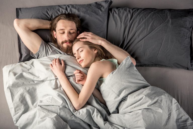 Couple sleeping cool in bed