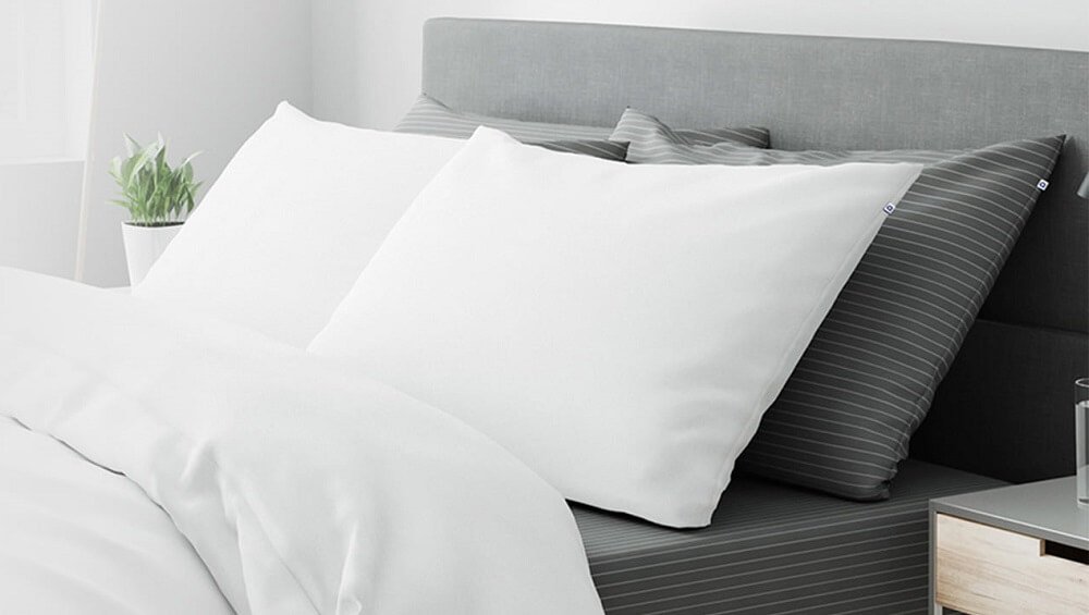A bed with mix and match percale sheets and matching pillowcases