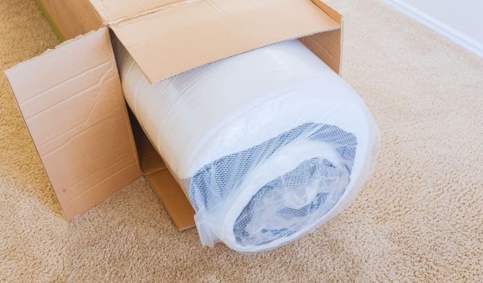 A Folded Memory Foam Mattress Vacuum Packed and In Its Box